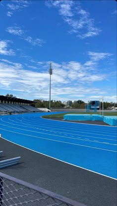 an empty stadium with blue skies and white clouds