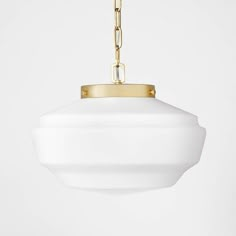 a white light hanging from a gold chain