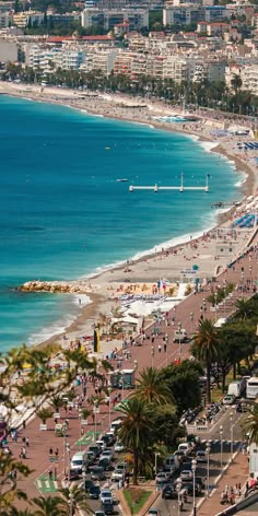 the beach is crowded with people and cars