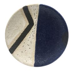 a blue and white plate with black lines on the side, against a white background