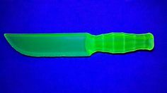 a green knife sitting on top of a blue surface