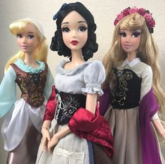 three dolls are standing next to each other