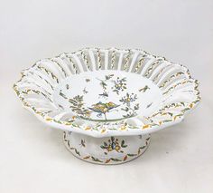 a white bowl with yellow flowers and birds on it