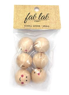 six wooden balls with faces on them in plastic wrapper bag for crafting and decoration