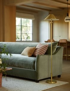 a living room filled with furniture and a lamp