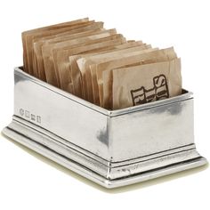 a metal container filled with lots of brown paper bags on top of a white surface