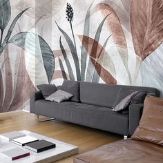 a living room with a couch, coffee table and wall mural