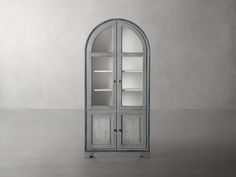 an arch - shaped cabinet with glass doors in the middle and shelves on either side