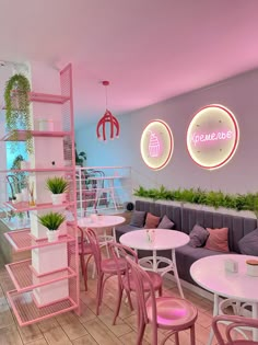 the inside of a restaurant with pink chairs and white tables, potted plants on shelves