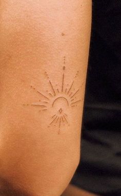 a person with a sun tattoo on their arm