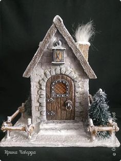 a small house made out of stone with a door and window on the front side