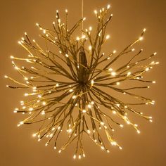 a chandelier with lights hanging from it's sides and branches in the middle