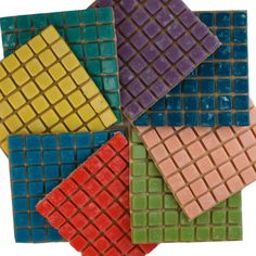 four different colored tiles arranged on top of each other in the shape of squares