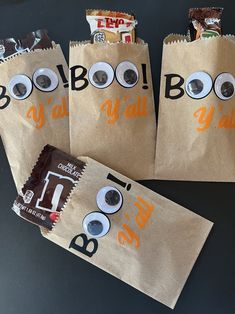 three brown paper bags with googly eyes and eyeballs on them are sitting on a table