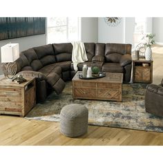 a living room filled with furniture on top of a hard wood floor covered in rugs