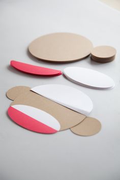 several pieces of paper are arranged on a table with circles and shapes cut out of them