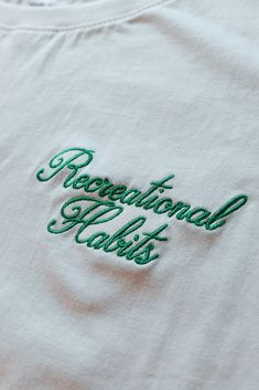 a white t - shirt with green lettering on the front that says, regional heights