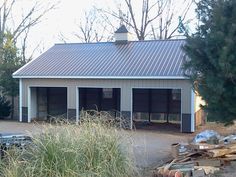 a horse barn with two stalls on the roof and one stall in the back yard