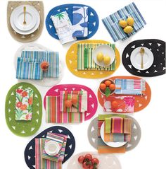 colorful plates and place mats are laid out on the table