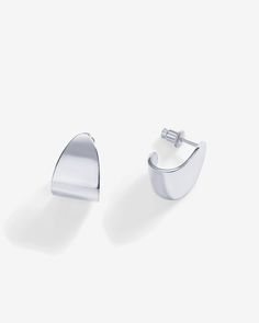 Trendy and chic, these 16mm long and 12mm wide earrings feature an abstract design, making a bold statement. Lightweight and chunky, these hoops offer an elegant blend of sophistication and modern style.Materials 14K yellow gold or white gold plated. s925 Sterling Silver Posts. Measurements: Length: 16mm; Width: 12mm. Hypoallergenic; nickel, lead, and cadmium free. Modern Metal Huggie Earrings For Formal Occasions, Modern White Gold Tarnish Resistant Huggie Earrings, Modern Tarnish Resistant White Gold Huggie Earrings, Modern Tarnish-resistant White Gold Huggie Earrings, Modern White Gold Tarnish-resistant Huggie Earrings, Modern Sterling Silver Huggie Earrings For Formal Events, Modern Sterling Silver Huggie Earrings For Formal Occasions, Modern Pierced Huggie Earrings, Minimalist Metal Huggie Earrings For Formal Occasions