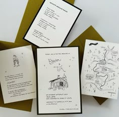 three cards with drawings on them sitting next to some brown envelopes and green paper