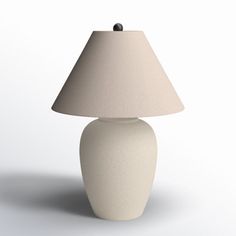 a white table lamp with a beige shade on it's base and a black button at the top