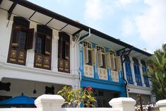 a blue and white building with wooden shutters