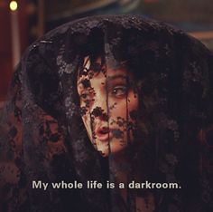 an image of a woman with black hair and words on her face that says, my whole life is a darkroom