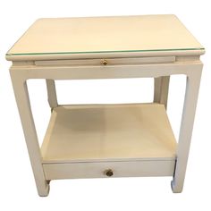 a white table with two drawers on one side and an open drawer on the other