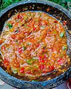 a pan filled with food sitting on top of a wooden table