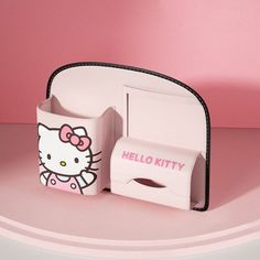 a hello kitty tissue dispenser sitting on top of a pink countertop