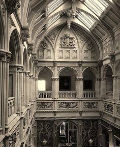 an ornate building with many windows and balconies on the second floor is shown in black and white