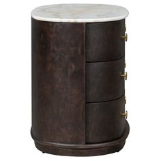 the side table has three drawers with brass handles and marble top