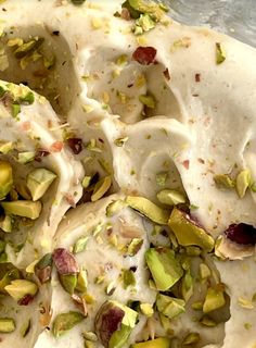 a pizza topped with pistachios and cream sauce