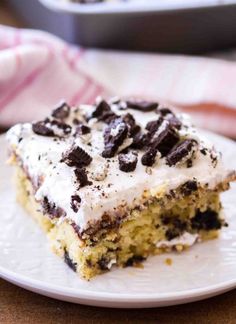 a close up of a piece of cake on a plate with a fork and napkin in the background