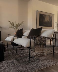 a living room filled with furniture and a fire place next to a wall mounted tv