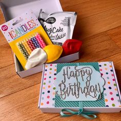 an open birthday box sitting on top of a wooden table