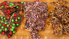 three different types of candy bars on a cutting board with nuts and sprinkles