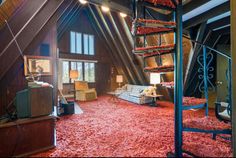 a living room filled with lots of furniture and red carpet