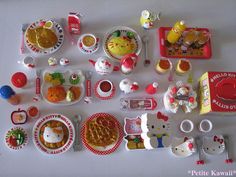 a white table topped with lots of toys and food