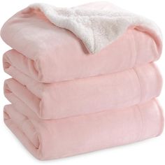 three pink blankets stacked on top of each other