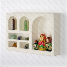 there is a shelf that has many different items on top of it, including figurines and stones