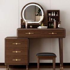 a dressing table with a mirror and stool next to it