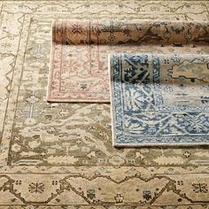 three rugs laid on top of each other with different colors and patterns in them