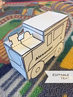 an open cardboard box sitting on top of a colorful rug with the word alexnderr printed on it