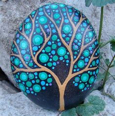 a painted rock with a tree on it