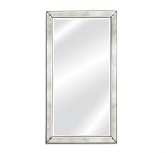 a silver framed mirror on a white wall