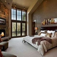 a large bed sitting in a bedroom next to a fireplace