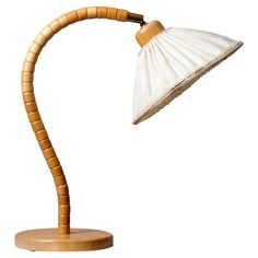 a wooden desk lamp with a white shade on it's head and bamboo arm