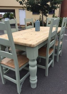 a wooden table with six chairs around it